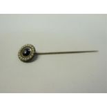 A gold stick pin set with enamel Seed Pearl and Diamond. 6.6cms l.