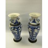 A pair of early 19c Chinese baluster vase and covers, blue on white decorated ladies in veranda