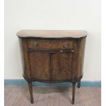 A 19c mahogany side cabinet of serpentine from fitted one long frieze drawer over cupboard base