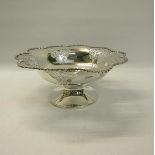 A silver fruit bowl of circular shape form with cast leaf and flower outer rim. Pierced panels on