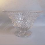 A crystal centre bowl, diamond cut and wheel engraved around rim with garlands of flowers on a