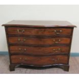 A George III figured mahogany serpentine chest of four long graduated drawers with brass swing