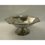 An Edwardian silver fruit bowl on stand, the bowl of octagonal form with flared rim cast with