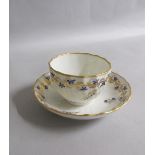 A Derby spiral Relief fluted tea bowl and saucer with gilt entwined sprig border within a gilt