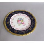 An early 19c Derby hand painted plate, view in Derbyshire with a deep blue border and gilt rim