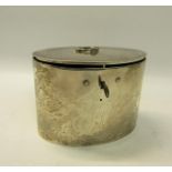 A George III silver locking tea caddy of oval form with hinged cover having ring pull central