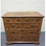 An 18c figured walnut chest of two short and three long graduated drawers. The top with wide cross