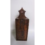 A 19c burr wood wall hanging candle box with sliding cover. 16cms w 46cms h.