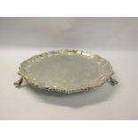 A mid Victorian silver salver of circular form with raised and embossed beaded border, supported