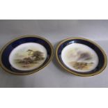 A pair of Royal Worcester circular dishes by John Stinton, one with highland cattle in misty