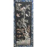 A 19th century Chinese silk embroidered panel depicting birds in a tree with berries and blossom