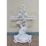 A Victorian cast iron stick stand cast as a seated dog under a tree, white painted. 72cms h.