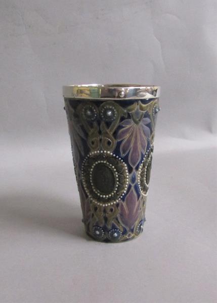 A Doulton Lambeth Arthur Pearce silver rimmed beaker with incised foliate decoration and four