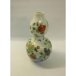 A 19c double gourd vase painted with flowers and insects, double blue circle mark to base. 22.5cms