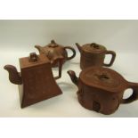 A collection of four 19c Oriental red clay teapots with applied moulded decoration, two with