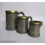 A set of three George V ale measures, a quart, a pint and half pint with LCC license stamps and