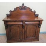 A mid Victorian panel back chiffonier, the panel back with applied scroll mouldings and fitted two