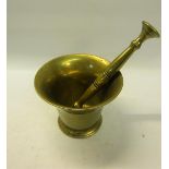 A late 18/early 19c brass mortar and pestle, the mortar with 13cm mouth, 10cm h.