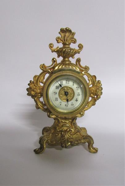 A late 19c American mantel clock by the Amsonia Clock Co. in rococo cast gilt case embellished