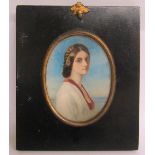 A 19c watercolour portrait of a lady, oval framed and glazed. 11cms x 8cms.
