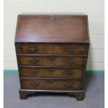 A late Georgian mahogany bureau with fall front and fitted interior over three long drawers and