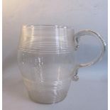 An early 19c baluster tankard with two deep bands of ribbing and having an applied moulded scrolling