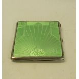 An art deco silver and enamel cigarette box, the green enamel cover with a sunburst design. London