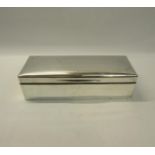 A silver cigarette box of rectangular form with a hinged and slightly domed cover. Makers mark for