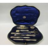 An eight piece silver handled manicure set, manufactured by George Unite, Birmingham 1922. In fitted