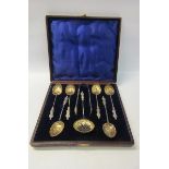 A boxed set of six late Victorian silver apostle teaspoons with shell shaped gilt lined bowls