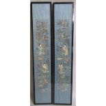 A pair of late 19th century Oriental blue silk panels, the silkwork depicting four ladies in