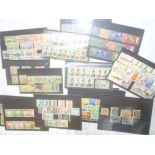 Various stock cards containing Commonwealth sets of stamps including Solomon Islands, Burma, Brunei,