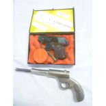 An old nickel plated spring action air pistol and a Perfecta starting pistol,