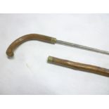 An old swordstick with steel square section blade in rustic walking stick mounts