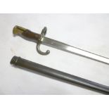 A French Gras bayonet with triangular steel blade dated 1878 in steel scabbard with matching
