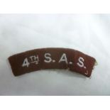 An original embroidered cloth shoulder title "4th S.A.S.