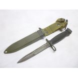 A Second War United States M8 knife bayonet with single-edged blade in scabbard with webbing frog