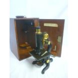 A good quality brass mounted and painted metal monocular microscope "The Service" microscope by W