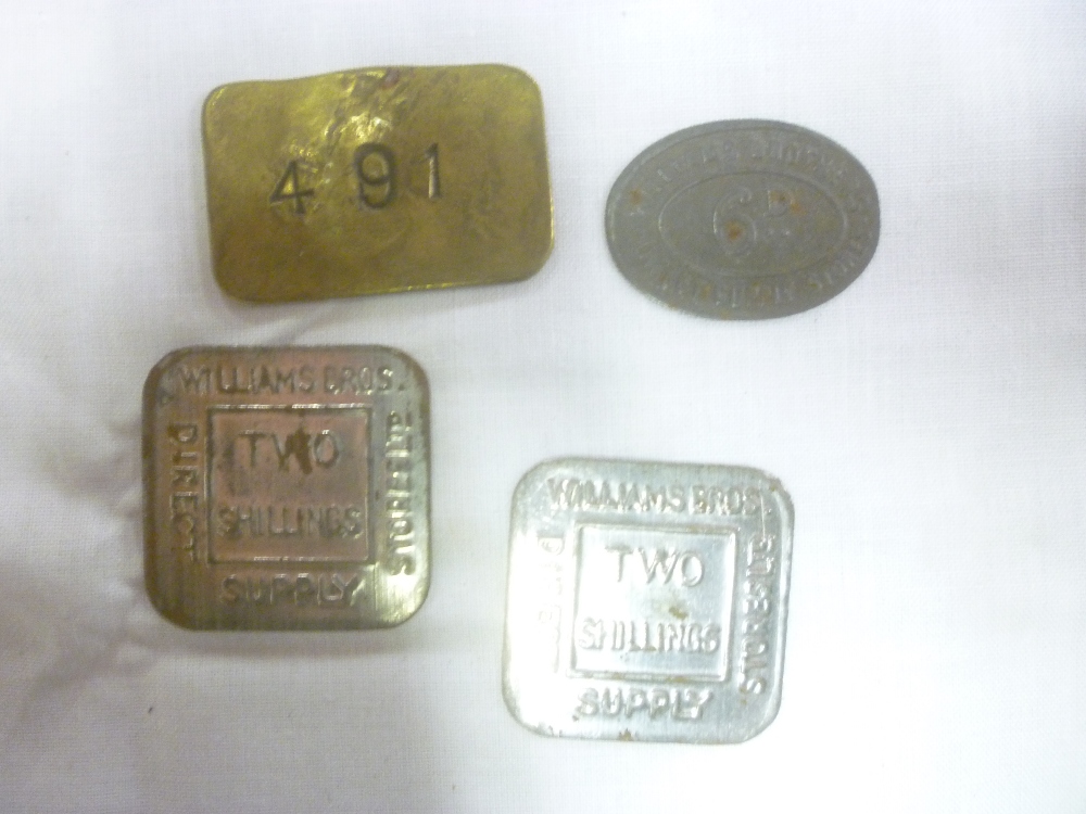 Three Williams Brothers pressed metal tokens and a brass rectangular pay check