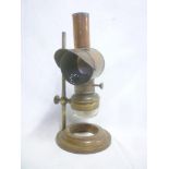 An old brass and copper microscope oil lamp by Negretti and Zambra of London with shrouded top and