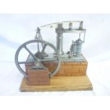 A good quality model steam driven beam engine with fly wheel on rectangular wooden base 16" long