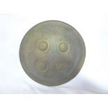 An Indo-Persian brass circular dahl shield with four raised bosses 11" diameter