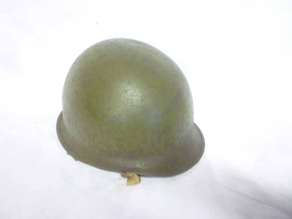A Second War United States steel combat helmet with liner