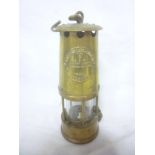 A brass miner's lamp by the Protector Lamp & Lighting Co.