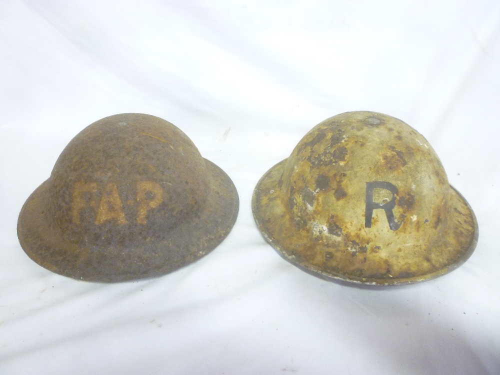 Two Second War Home Service helmets in relic condition "F.A.P.