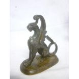 An old bronze figure of a seated Griffin on oval base,