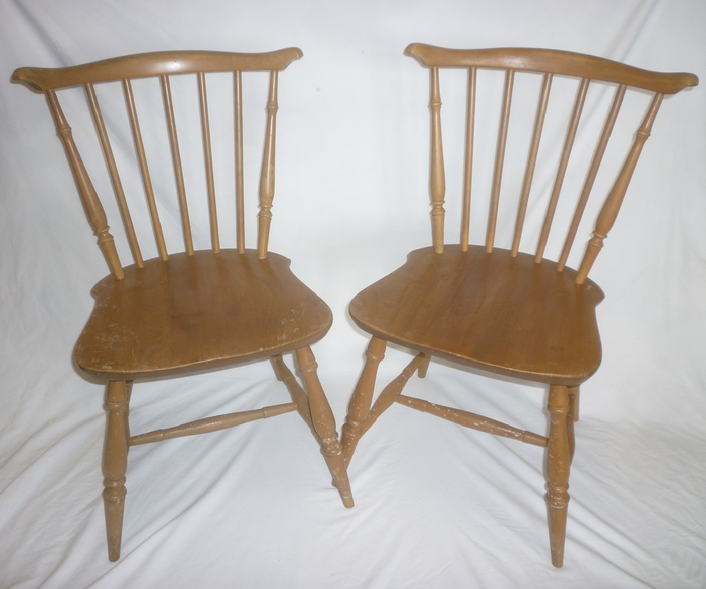 A set of four 1960's Ercol light elm spindle-back dining chairs with curved backs and plain seats