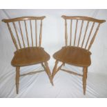 A set of four 1960's Ercol light elm spindle-back dining chairs with curved backs and plain seats