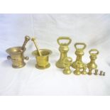 Two old bronze mortars and pestles and a selection of various brass bell weights