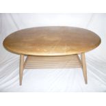 A 1960's Ercol light elm oval two-tier coffee table